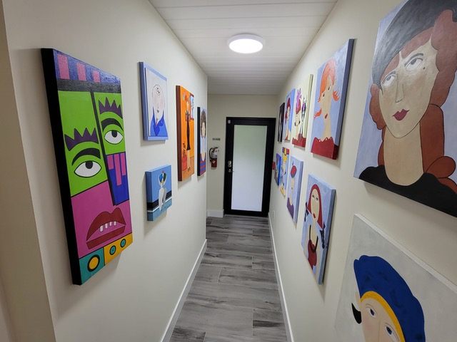 Hallway gallery wall at Mary's House ALF in Cutler Bay