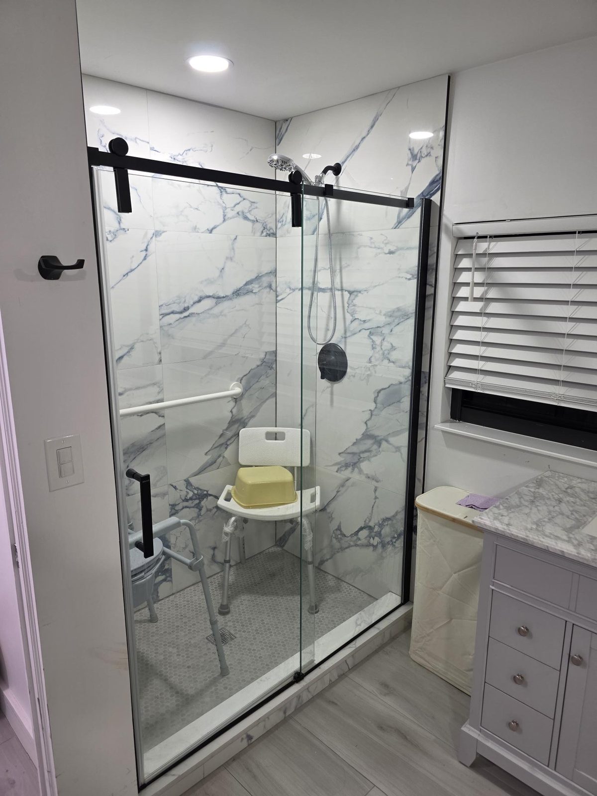 Walk-in shower with grab bar and shower chair at Mary's House ALF in Palmetto Bay